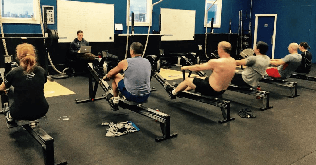 CrossFit athletes on rowing ergs