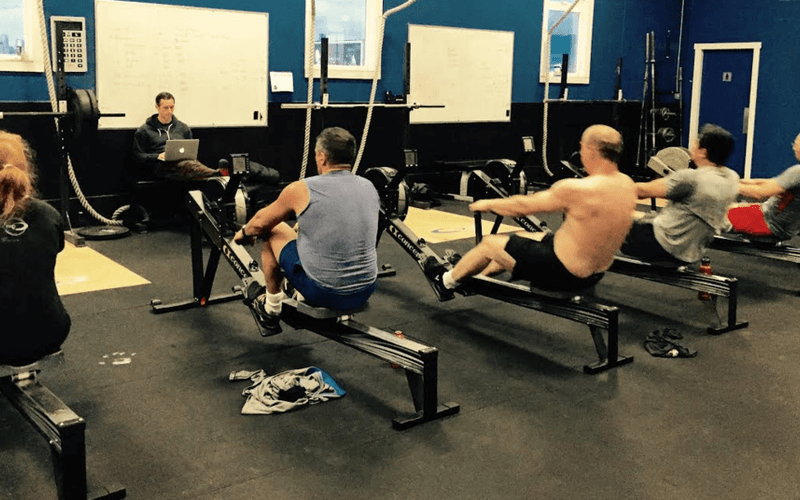 CrossFit athletes on rowing ergs